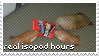 A stamp of an image of three isopods gathered around an older type of Doritos bag, with the text:'real isopod hours' in the bottom left. Must be really old.